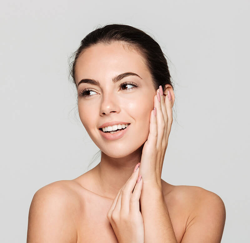 Young Woman Touching her Face After her Cosmetic Procedure