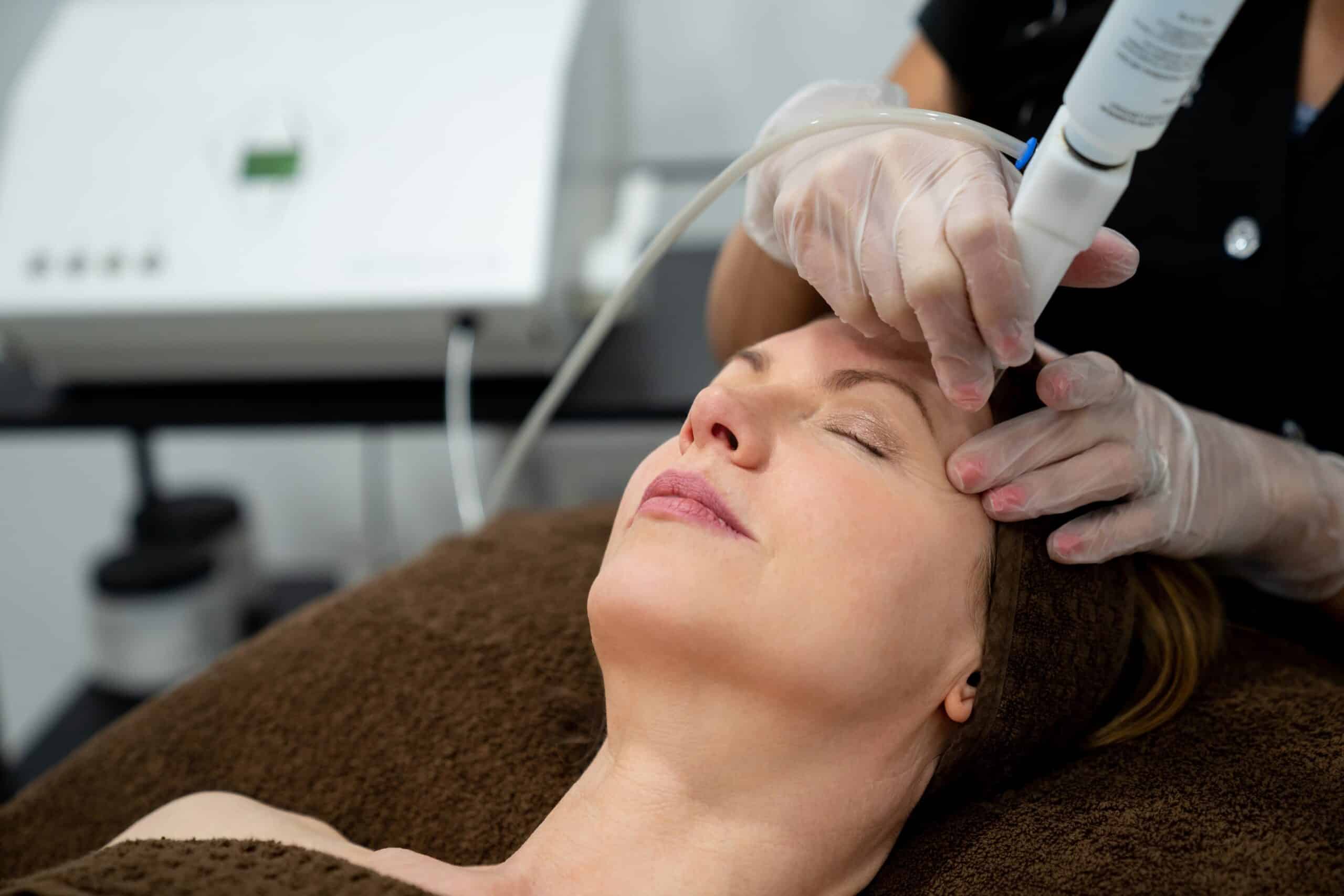 woman receiving diamondglow facial and other Aesthetician Services