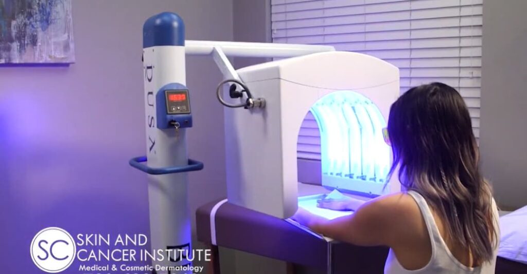 woman with her hands under the Levulan Kerastick + Blu-U machine