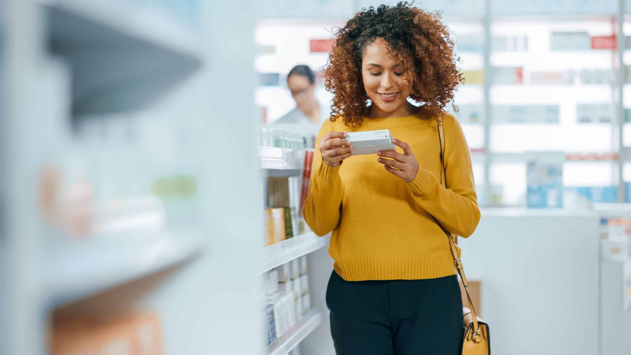 young woman looking at a prescription box in a physician owned dispensary