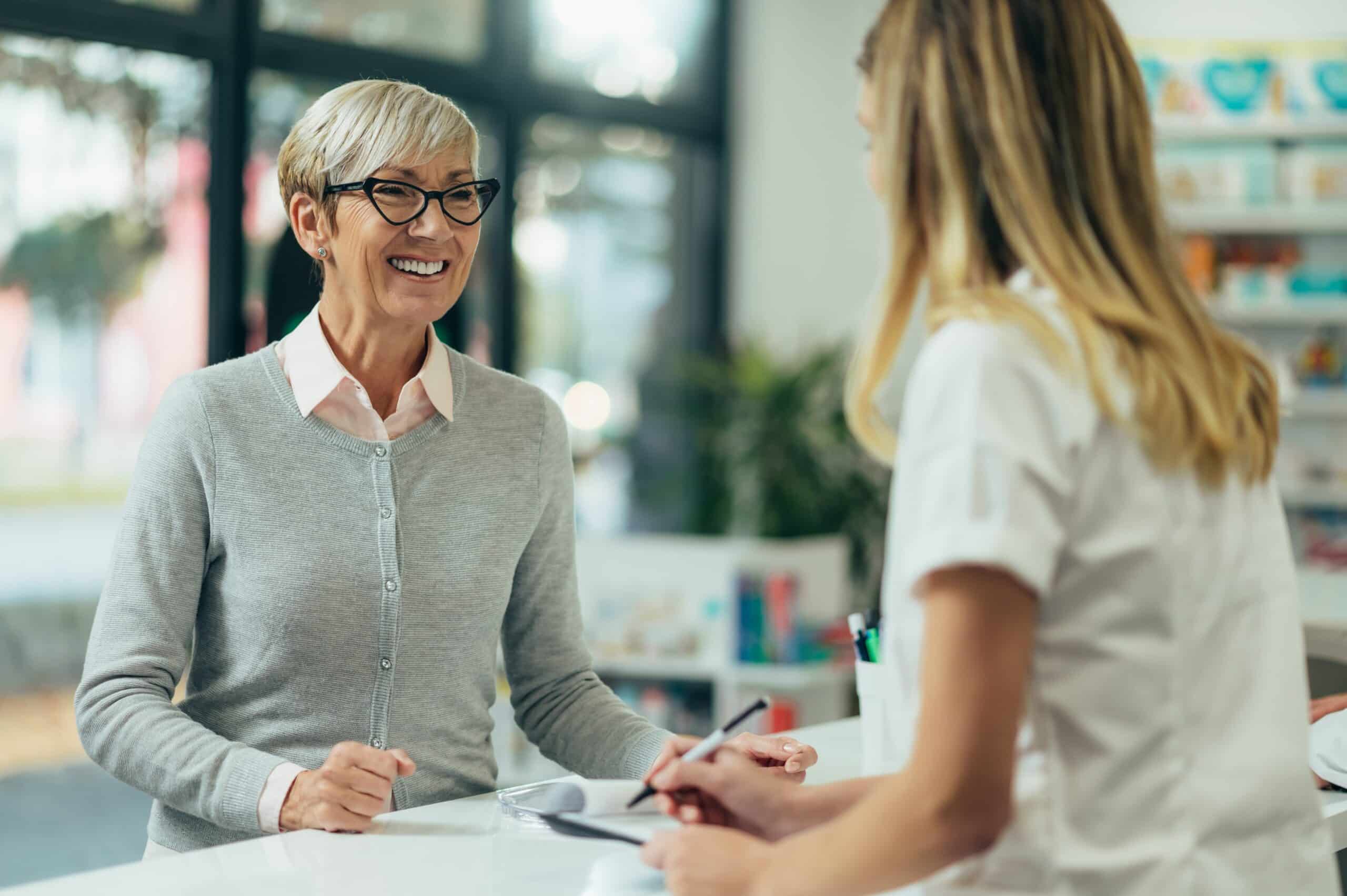 older woman smiling at a physician